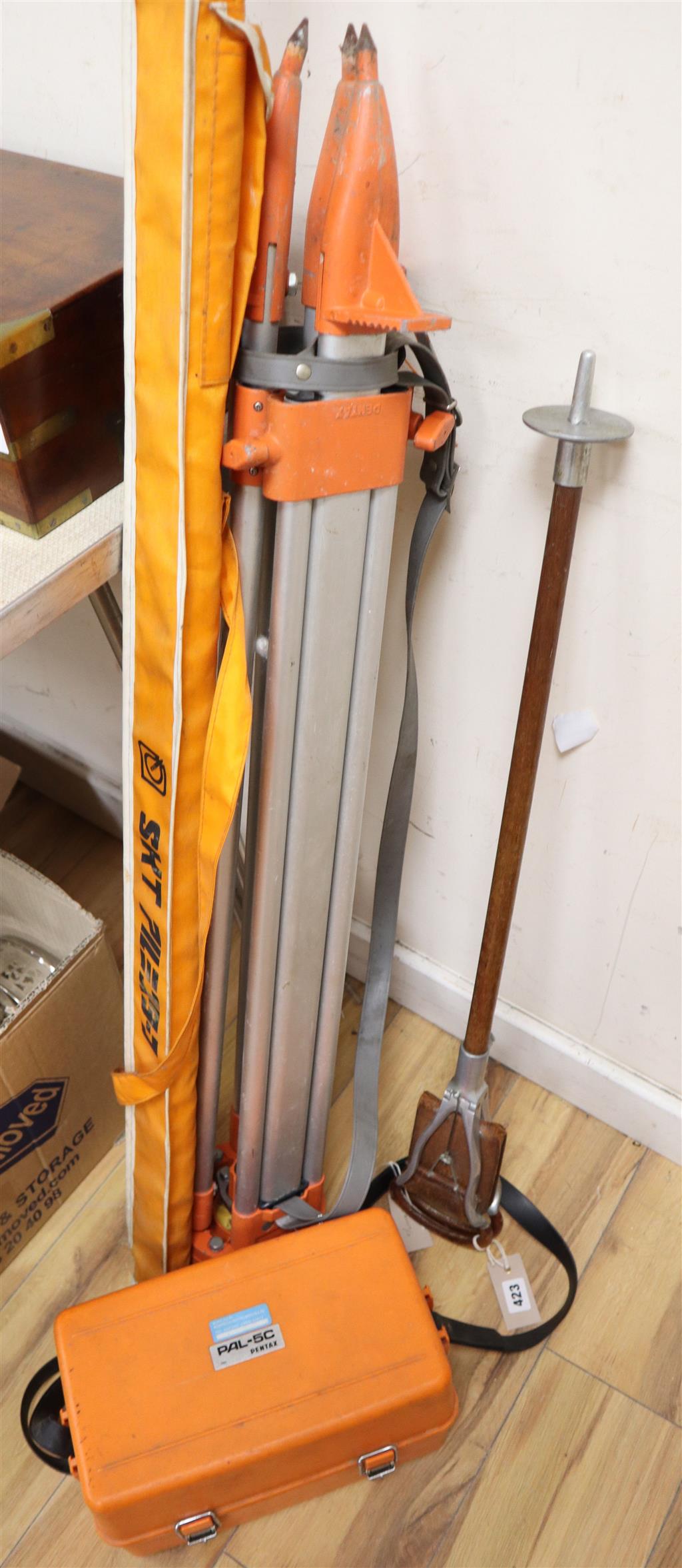 A 1960s Pentax architects level on tripod stand and 10 metre rod, together with aluminium leather and wood shooting stick